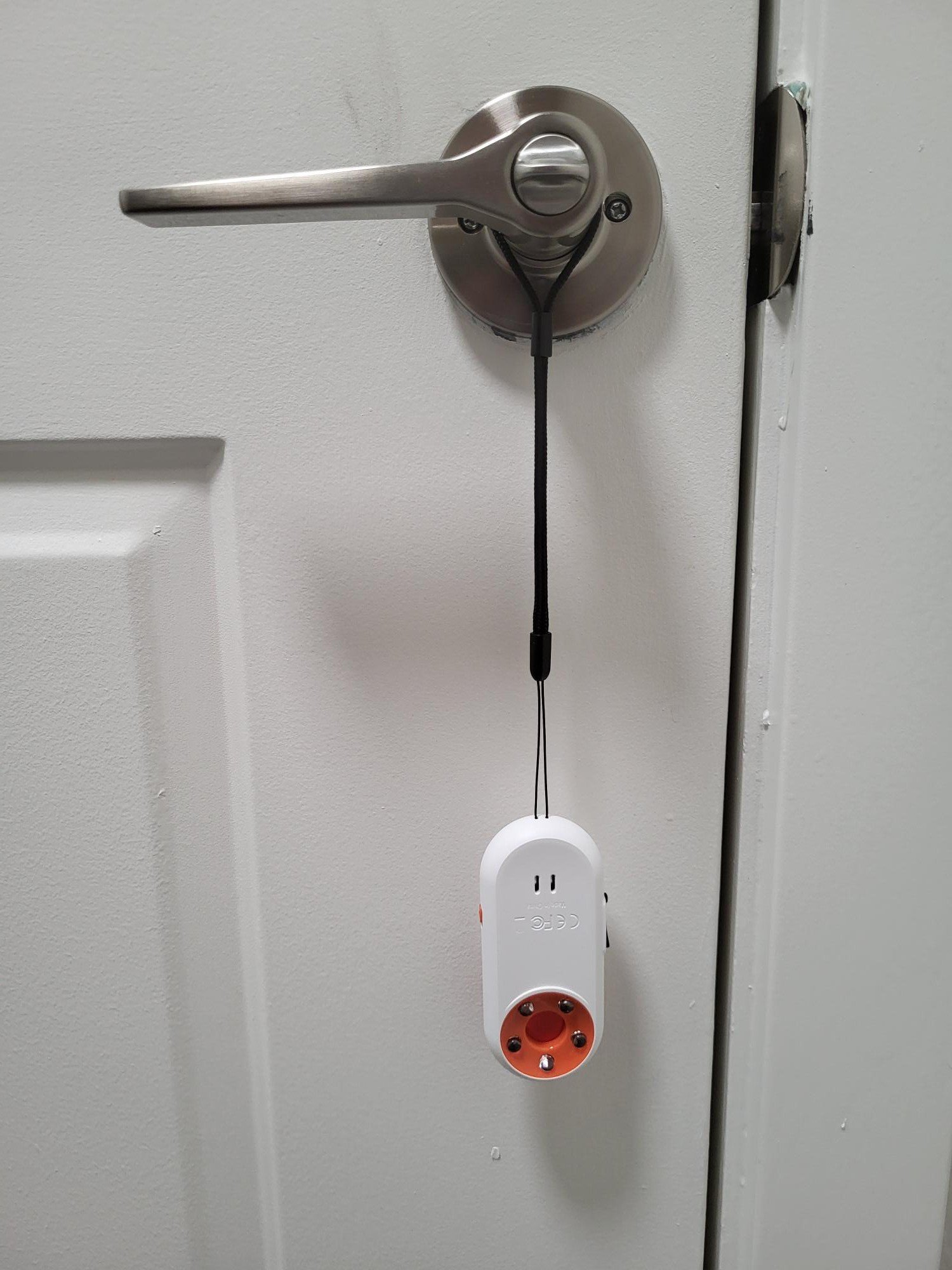ANKOSHUN 3-in-1 door alarm hanging on hotel door handle