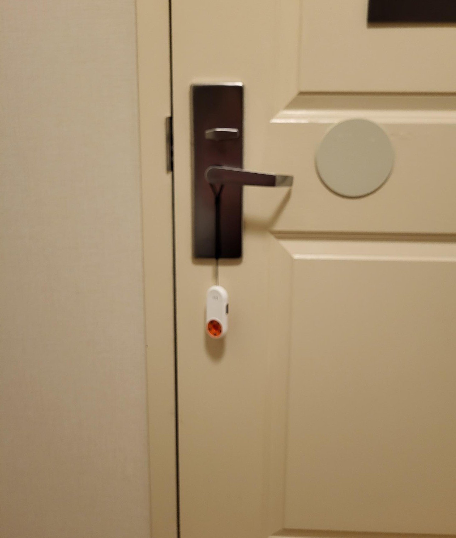 ANKOSHUN 3-in-1 door alarm hanging on hotel door handle