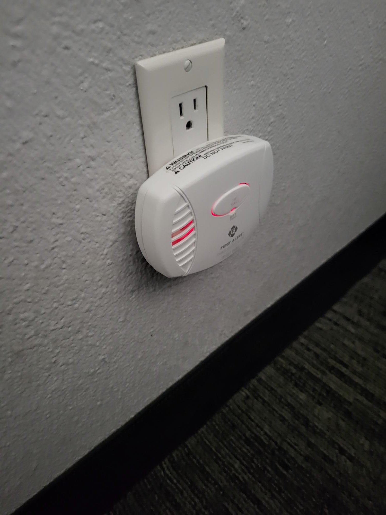 First Alert CO605B carbon monoxide detector plugged into wall outlet